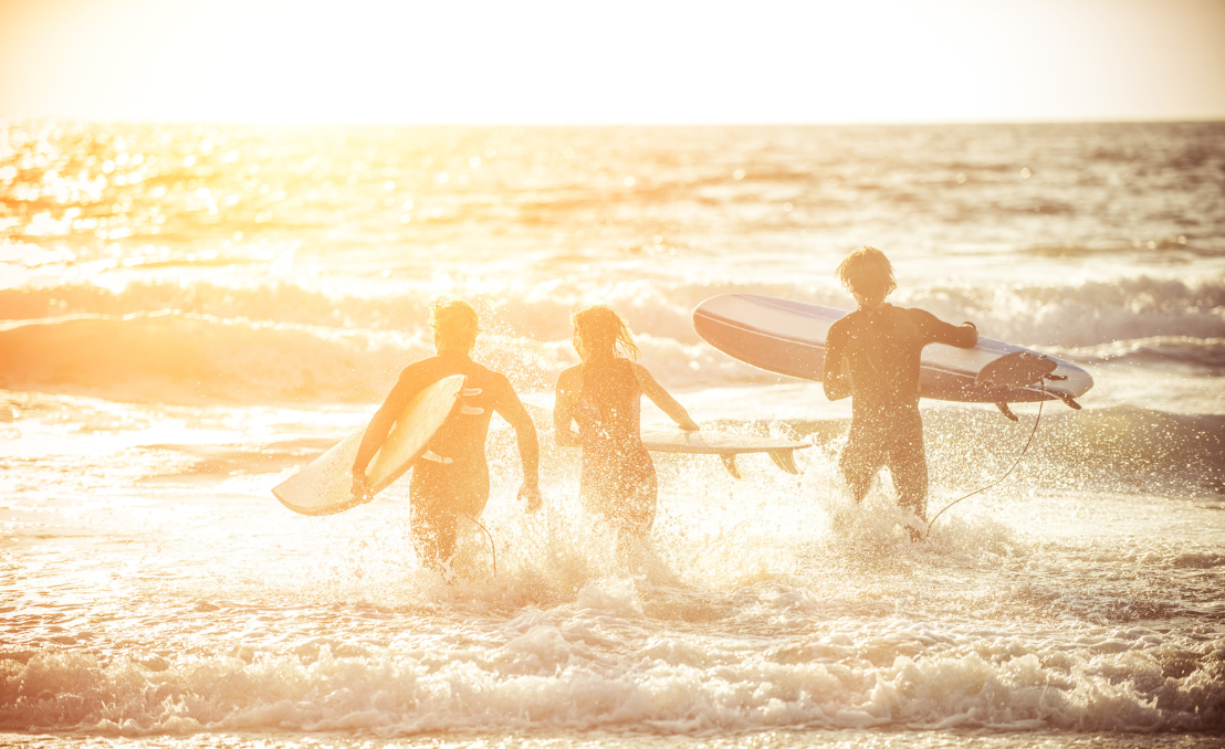 Surfers entering the sea with surfboards near Torres Vedras
